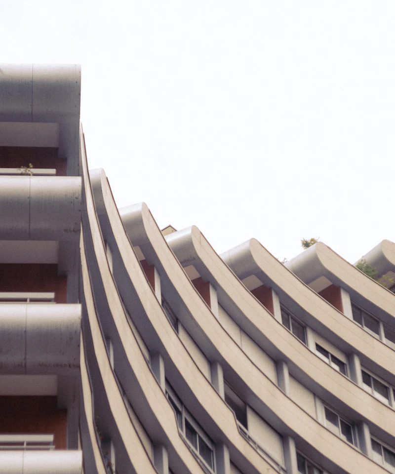 Curving concrete architecture photographed against a bright sky